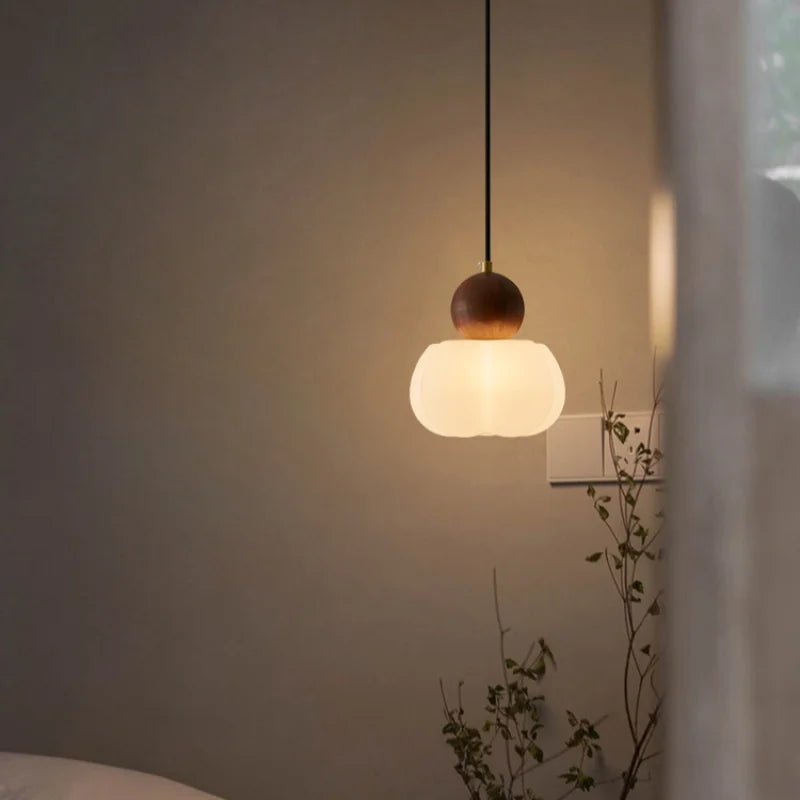Minimalist white chandelier shade pushing light downward in an even wash