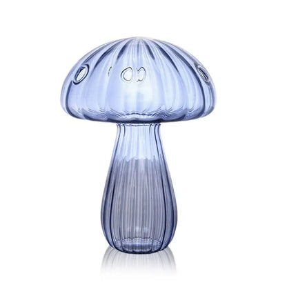Yellow mushroom glass vase in overhead flat lay on white marble surface
