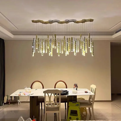 Hollowed metal tube chandelier with slim plated tubes at staggered lengths