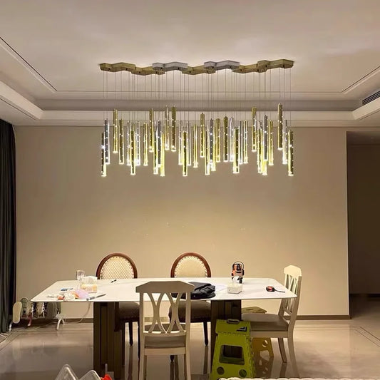 Hollowed metal tube chandelier with slim plated tubes at staggered lengths