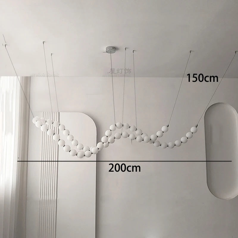 Gold linear strip chandelier at 39.4 in length above a table