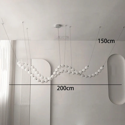 Gold linear strip chandelier at 39.4 in length above a table