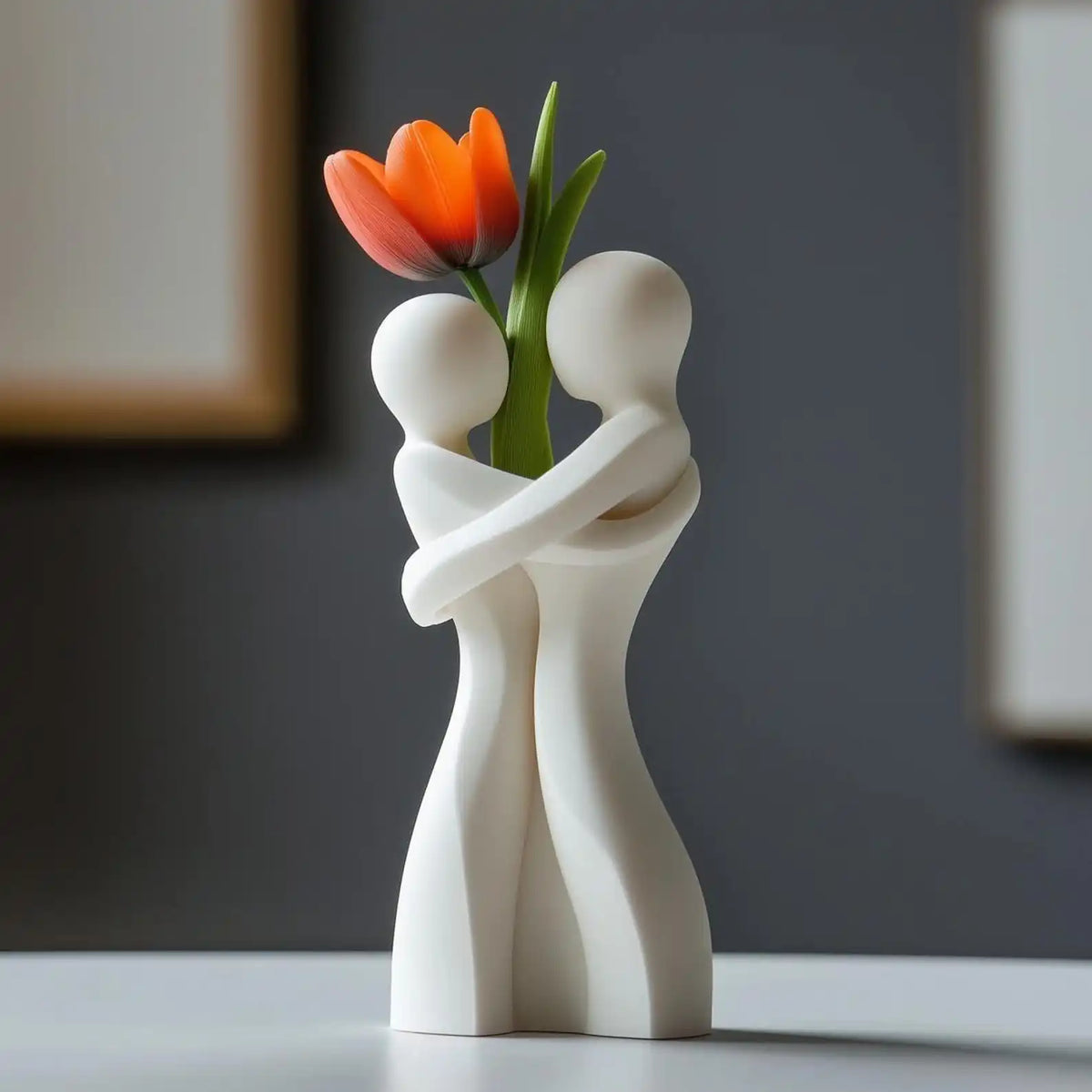 White ceramic hugging couple vase forming heart silhouette on romantic dining table setting