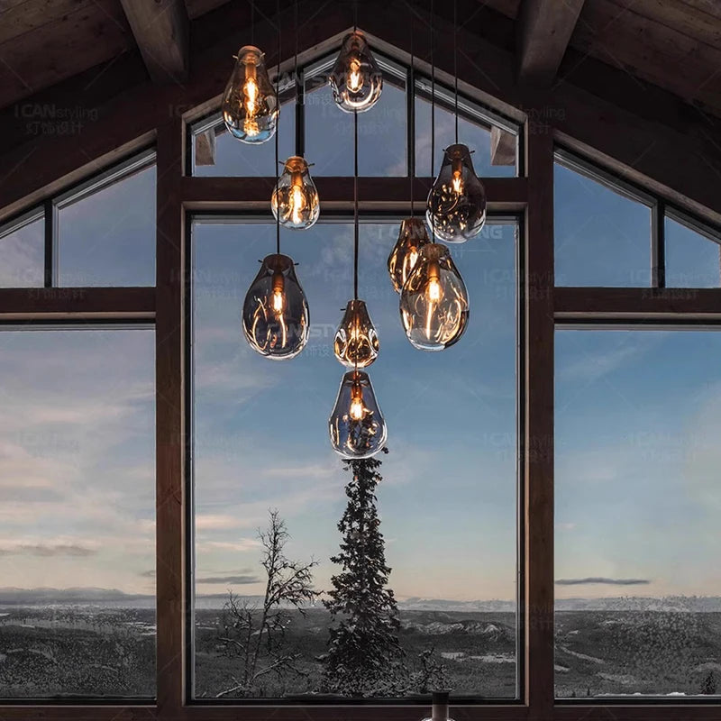 Glass shade chandelier lit in warm white above a dining table