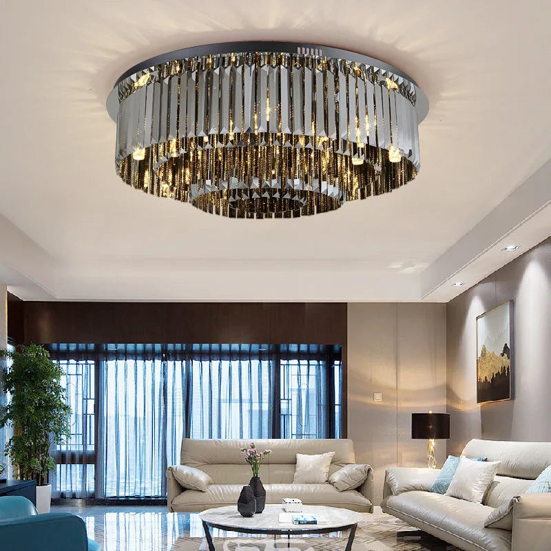 Modern black crystal chandelier lit in warm light above a dining table