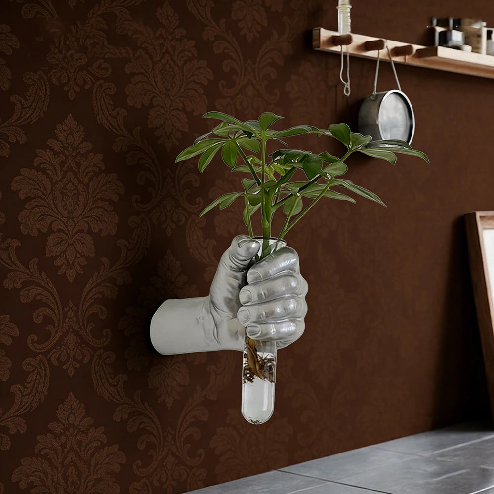 Boxer grip resin wall vase with single red rose stem in eclectic interior