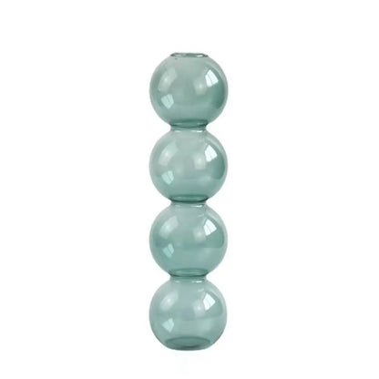 Romantic pink and blue glass vases in couples theme arrangement with decorative accents