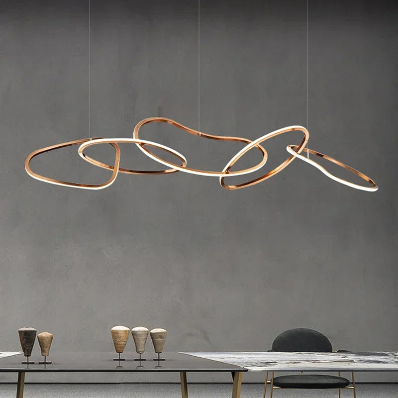 Rose gold circle chandelier with brushed steel discs on a flush plate