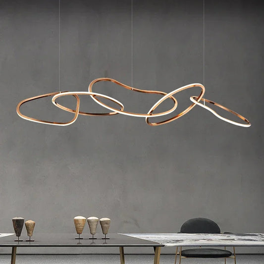 Rose gold circle chandelier with brushed steel discs on a flush plate