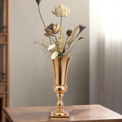 Wedding reception table styled with gold metal flower stand vases in a row