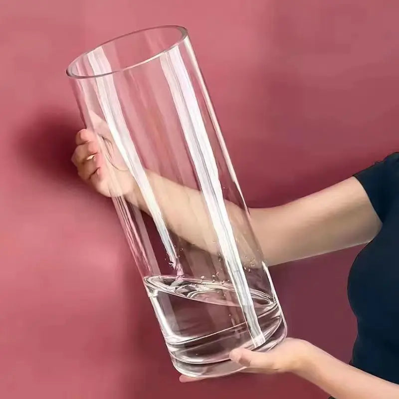 Medium acrylic cylinder vase holding peonies on a dining table display
