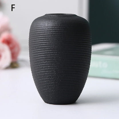 Black ceramic vase style B from side profile showing elegant waisted silhouette form