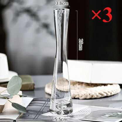 Minimalist setting with single slanted glass vase and green stem