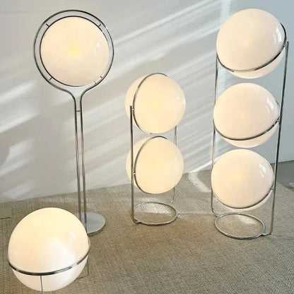 Chrome floor lamp white lampshade variant in modern living room setting