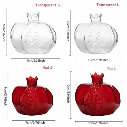 Mini pomegranate glass vase displayed on bookshelf with greenery