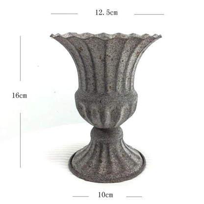 Close-up of white metal vase base showing weight and stability detail