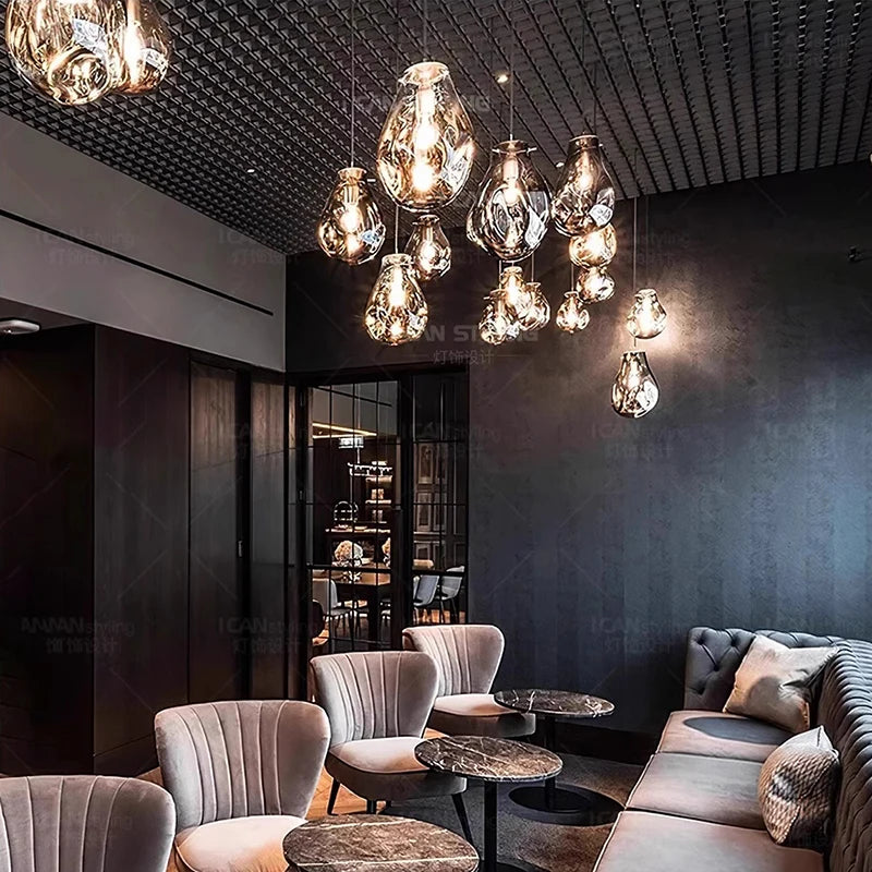 Cold white light through the glass shades of a steel chandelier