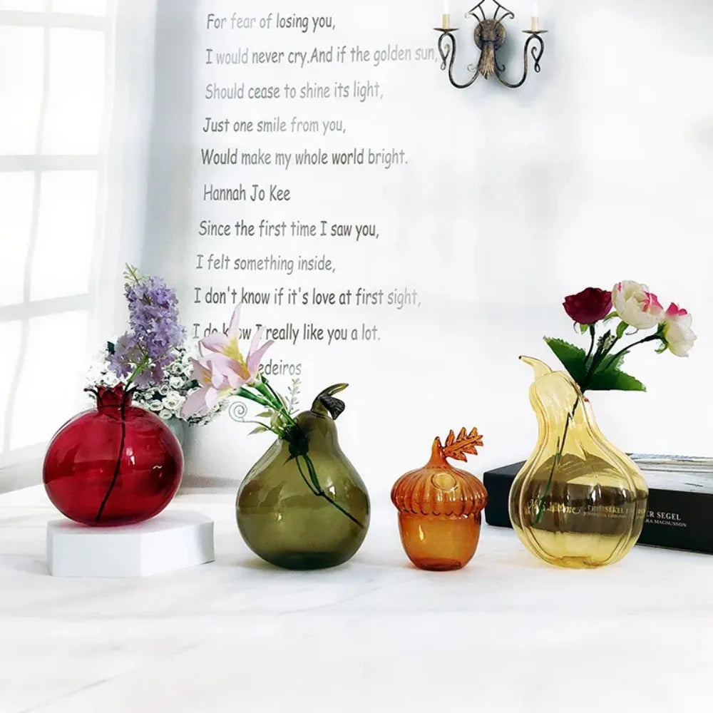 Glass zucchini-shaped bud vase holding a small flower cutting in water