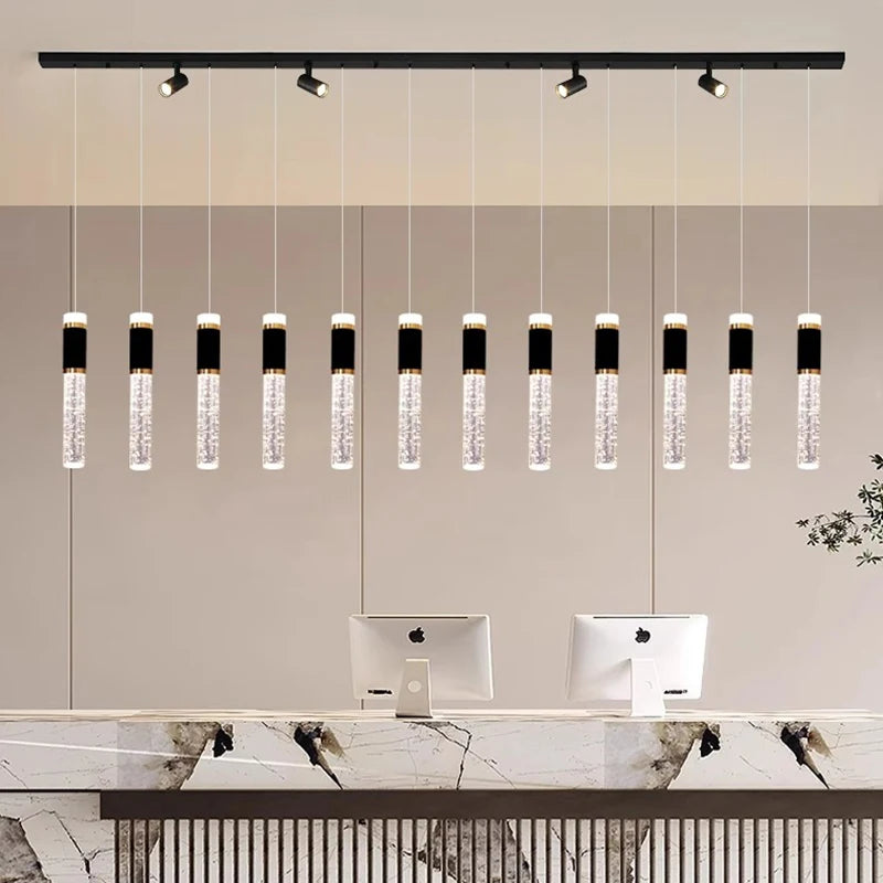 Linear crystal dining chandelier with crystal heads on brushed steel