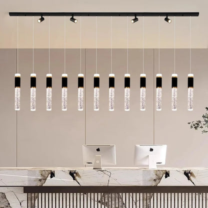 Linear crystal dining chandelier with crystal heads on brushed steel