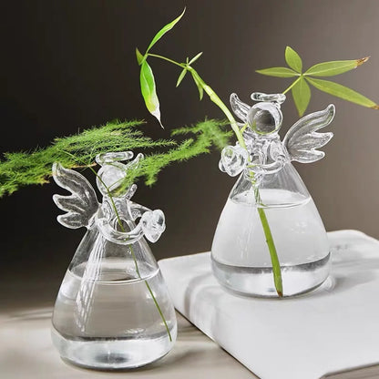 Mini crystal glass angel figurine vase standing on white marble shelf