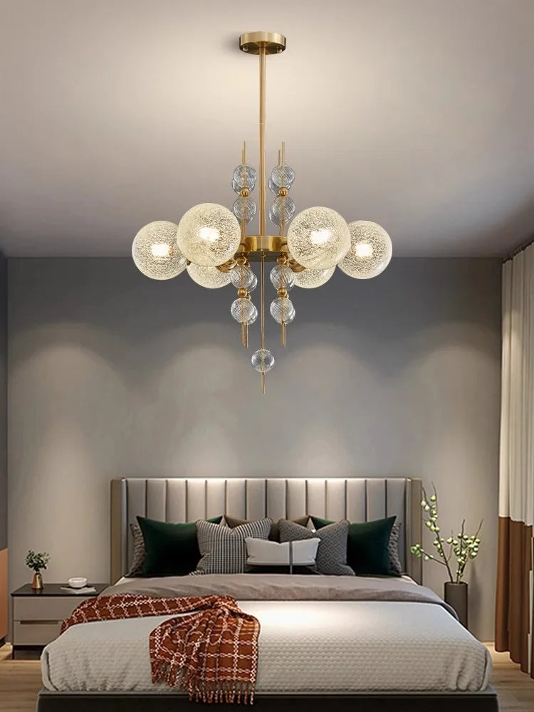 Matte glass sphere shade held on the chandelier polished steel arm
