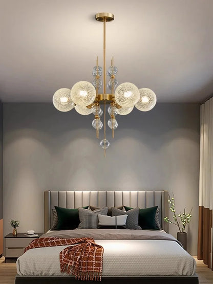 Matte glass sphere shade held on the chandelier polished steel arm