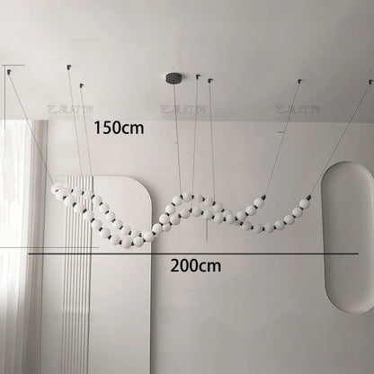 Black linear strip chandelier at 57.5 in length with warm light