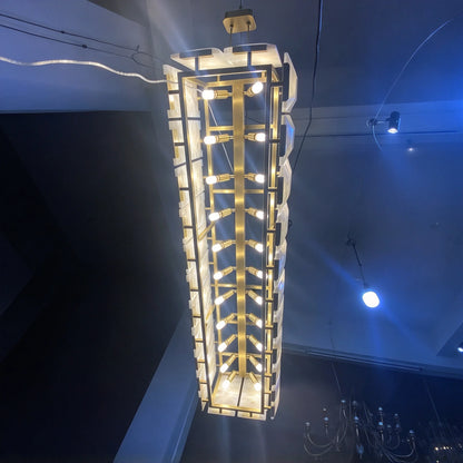 Black frame alabaster chandelier giving a continuous band of warm light