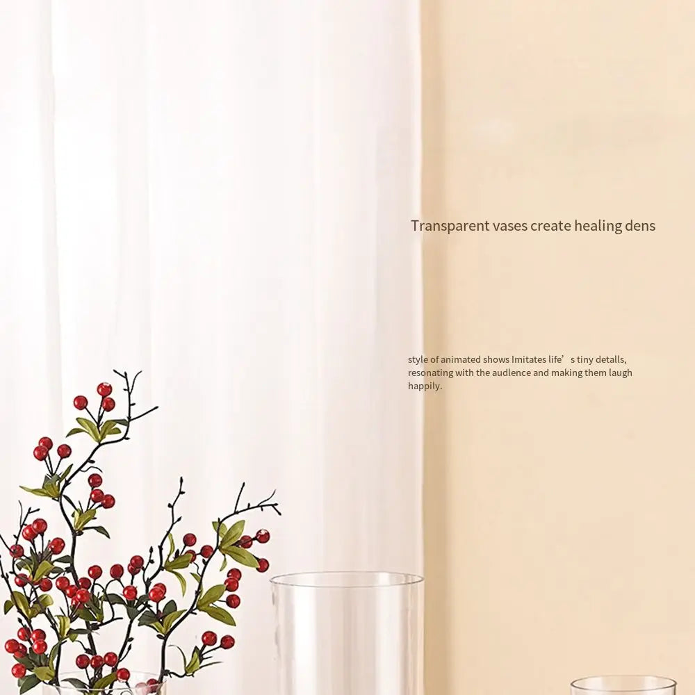 Transparent 10x30cm acrylic cylinder vase with single fresh stem on a side table