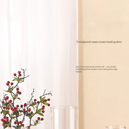 Transparent 10x30cm acrylic cylinder vase with single fresh stem on a side table