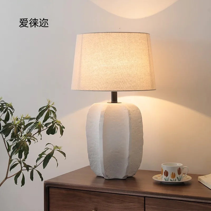 Handmade clay table lamp as decorative accent in living room corner