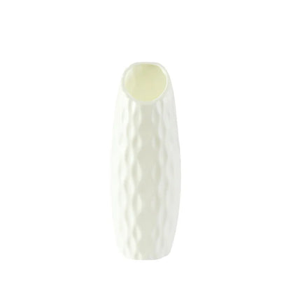 Zhi Qiao style Nordic plastic vase holding dried botanical stems on shelf