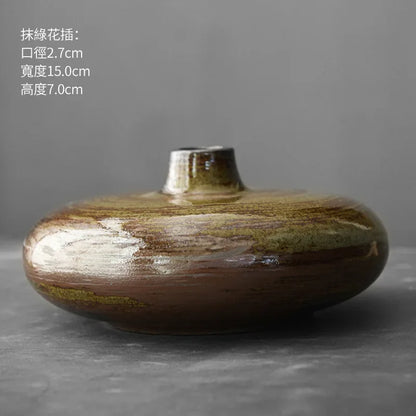 Japanese-inspired terracotta vase collection with varying heights on shelf