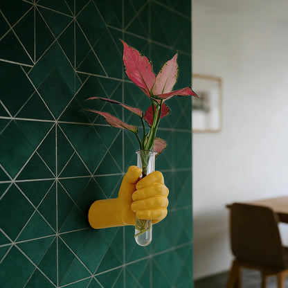 Close-up of resin fist detail gripping bud vase on eclectic gallery wall