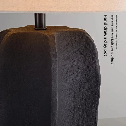 White handmade pottery lamp illuminated in warm ambient setting