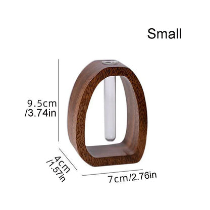 Close-up of walnut wood base and glass tube join on desktop hydroponic bud vase