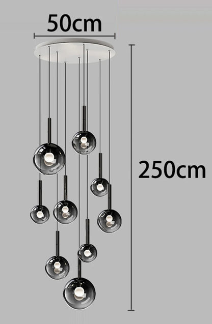 Staircase chandelier with individually suspended faceted glass elements