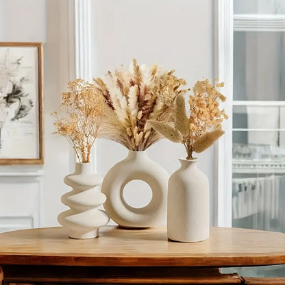 Three-piece boho ceramic vase set in varying heights on wooden shelf