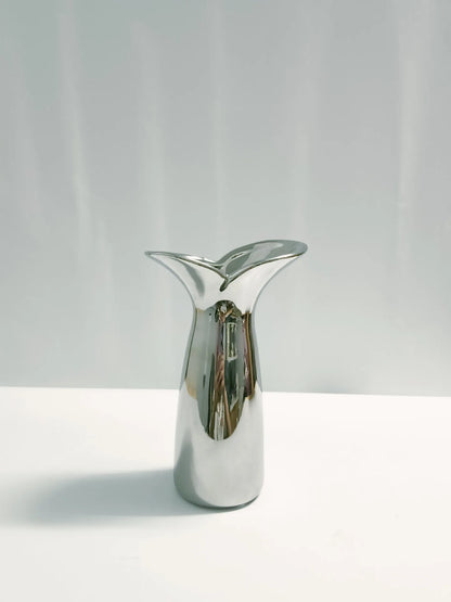 Large wabi-sabi metallic vase styled with dried pampas grass in contemporary living room