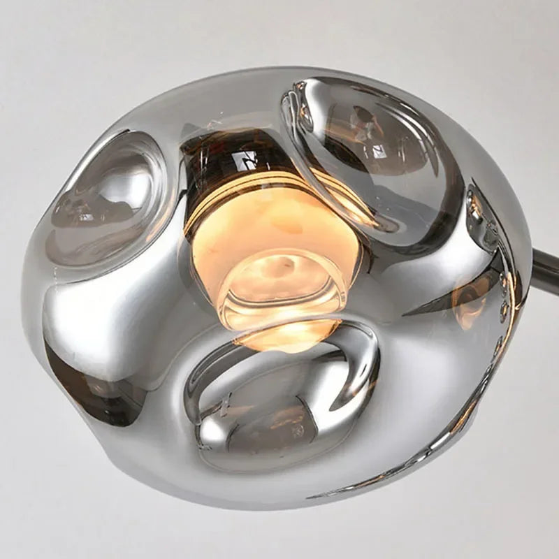 Smoked gray glass ball chandelier on a black pipe erected frame