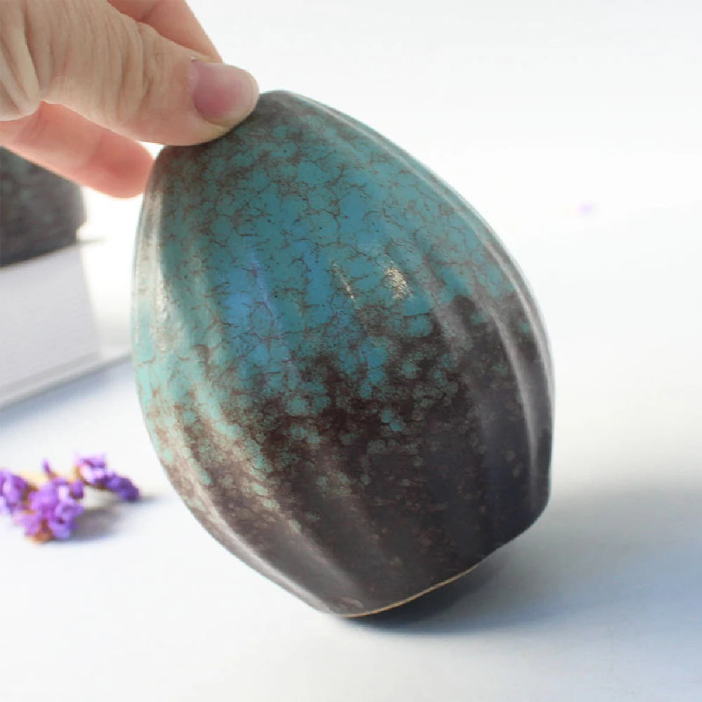 Five matte black Japanese ceramic bud vases in distinct organic sculptural shapes