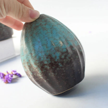 Five matte black Japanese ceramic bud vases in distinct organic sculptural shapes