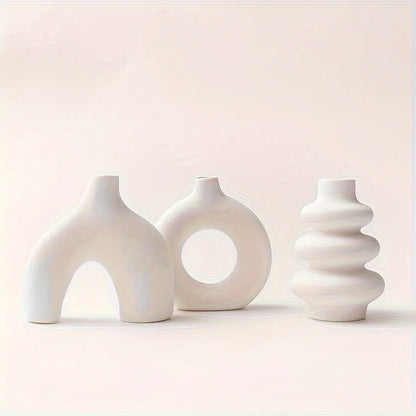 Light yellow ceramic vase from boho set with dried cotton stems on wooden shelf
