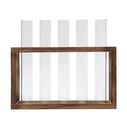 Glass tube hydroponic planter with growing herbs on contemporary shelf