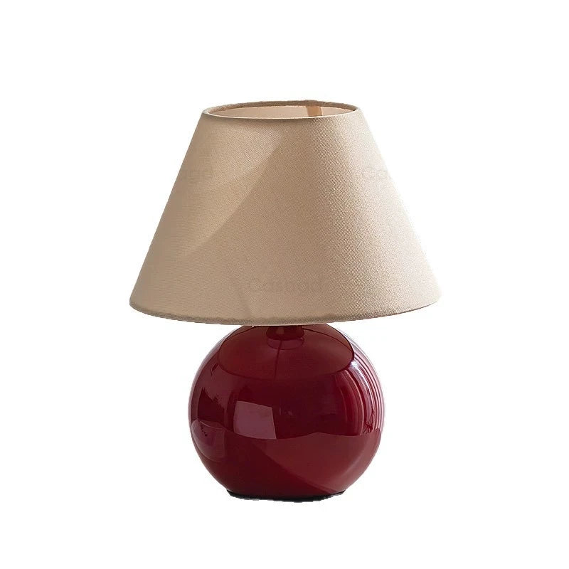French designer bedside lamp close-up showing base and shade junction