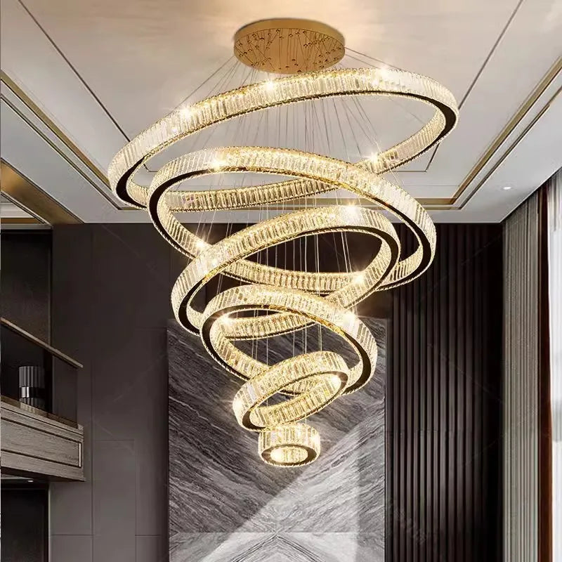 Warm white light across the crystal strands of a tiered ring chandelier