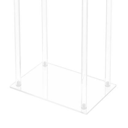 Multiple crystal clear flower stands arranged at varied heights in elegant wedding venue