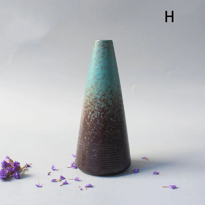 Set of Japanese ceramic small vases in varying styles on oak shelf