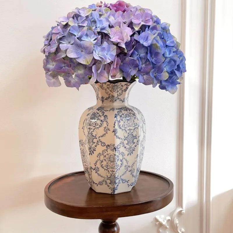 Close-up of hand-painted floral motif on blue and white porcelain vase